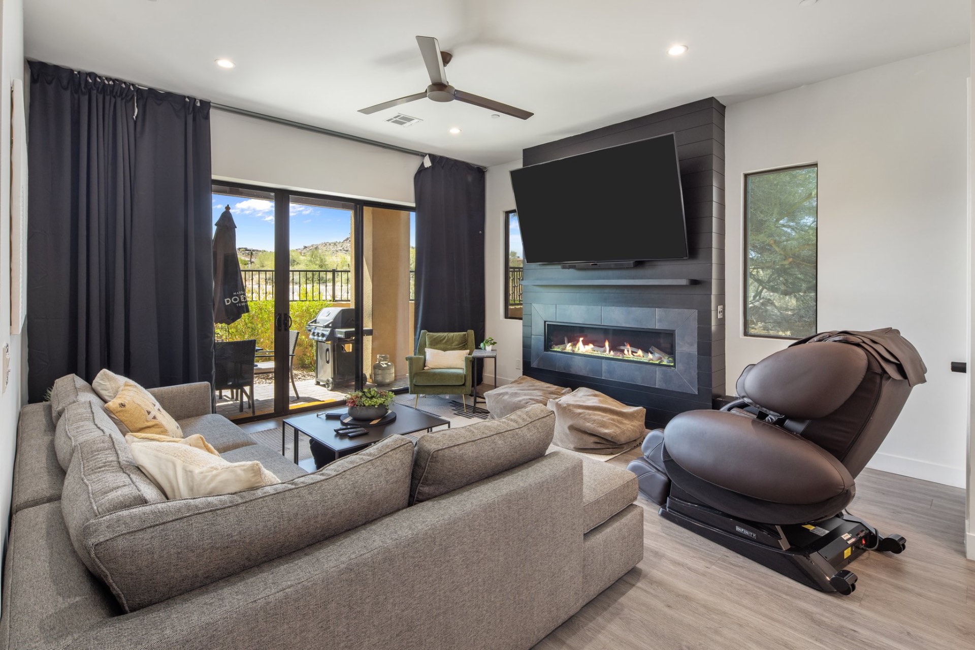 Living room with fireplace and mountain views at Villas at Troon North